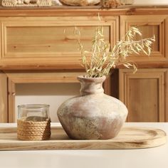 a vase sitting on top of a wooden tray