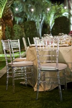 the tables are set up with white linens and chairs for an outdoor dinner party