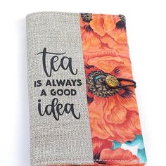 an orange and blue flowered notebook with the words tea is always a good idea