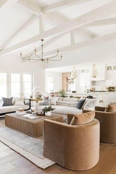 a living room filled with furniture and lots of windows