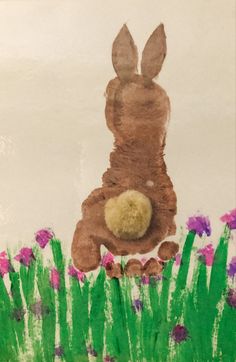 a child's drawing of a bunny sitting in the grass