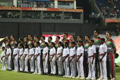 a group of men standing next to each other in front of a crowd on a field