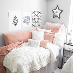 a bed with pink and white pillows in a bedroom