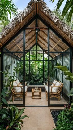 the inside of a tropical house with two chairs and a coffee table in front of it