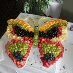 a butterfly made out of fruit on top of a table