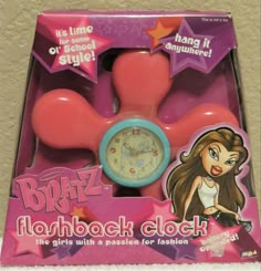 a pink and blue clock in a box with the words bratz on it's face