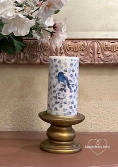 a blue and white vase sitting on top of a wooden table next to a mirror