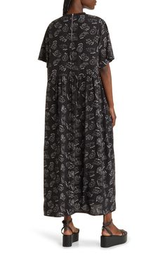 This soft T-shirt maxi is crafted in an oversized silhouette with an allover print and elbow-length sleeves. Crewneck Elbow-length sleeves Lined 100% polyester Hand wash, line dry Imported Black Short Sleeve Maxi Dress For Loungewear, Oversized Casual Maxi Dress For Daywear, Casual Oversized Maxi Dress For Daywear, Flowy Short Sleeve Maxi Dress For Loungewear, Flowy Maxi Dress With Short Sleeves For Loungewear, Oversized Graphic Print Short Sleeve Dress, Casual Short Sleeve Maxi Dress With Relaxed Fit, Spring Maxi Dress With Graphic Print And Short Sleeves, Black Relaxed Fit Maxi Dress For Loungewear