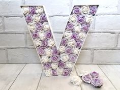 the letter v is made up of purple and white roses