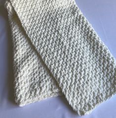 two crocheted white cloths sitting on top of each other