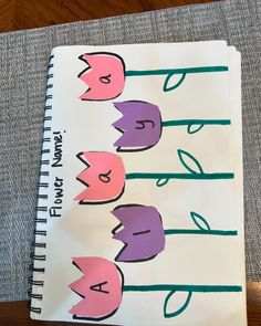 an open notebook with flowers drawn on it