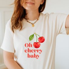 Cherry t shirt | summer t shirt | fruity t shirt | graphic tee FEATURES  -Premium Unisex T-Shirt -Fabric 100% cotton -Machine wash: warm (max 40C or 105F); Non-chlorine: bleach as needed; Tumble dry: medium; Do not iron; Do not dryclean. Please see the product images for help with sizing/our size guide. ABOUT CATTYWAMPUS SHOP Cattywampus is an old word, meaning fierce, and slightly awkward. A bit like us.  We are nothing to do with cats, but we do love them. We make bold, original and quirky gra Trendy Crew Neck T-shirt With Cherry Print, Retro Summer T-shirt With Front Print, Cute Short Sleeve T-shirt With Screen Print, Trendy Red T-shirt For Summer, Red Graphic Print T-shirt For Summer, White Print Text T-shirt For Summer, Casual Red T-shirt With Fruit Print, Relaxed Fit T-shirt With Fruit Print For Spring, Red Short Sleeve T-shirt With Fruit Print