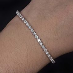 This brilliantly sparkling tennis bracelet has a classic design that will never go out of style! Featuring 3.23 carats of vibrant lab grown diamonds, this beauty offers brilliant, eye catching sparkle. This bracelet is sure to delight and would make an excellent gift for a special someone or for yourself.The diamonds are bright white and exceptionally clean, graded D-E VVS-VS. They are all excellent cut for fantastic sparkle! The diamonds are all lab grown, offering all the beauty and durability Sparkling Lights, Diamond Tennis Bracelet, Entrance Decor, Morning Wedding, Tennis Bracelet Diamond, Lab Created Diamonds, Tennis Bracelet, Lab Diamonds, Round Brilliant