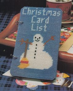 a cross stitch book sitting on top of a table