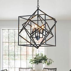 a chandelier hanging over a dining room table