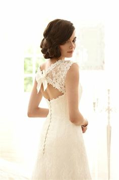 a woman in a wedding dress looking back