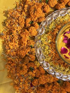 a glass bowl filled with yellow and purple flowers