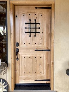 a wooden door with wrought iron bars on it