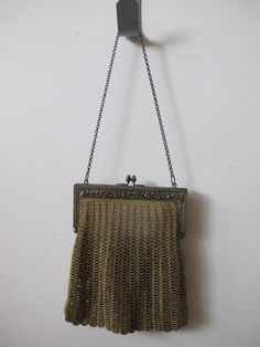 Beautiful vintage mesh purse in gold tone with beading. Steel gold tone frame has intricate heart and scrolling flowery design. Golden tone silk interior. Excellent condition, interior is coming undone at sides and has a light fraying tear. Frame to base measures 6 1/2" x 6 1 /2". Chain clutch measures 7".  10658-178 Vintage Handmade Gold Coin Purse, Vintage Gold Handmade Coin Purse, Handmade Vintage Gold Coin Purse, Antique Gold Rectangular Bag, Handmade Victorian Gold Bags, Antique Handmade Gold Evening Bag, Antique Gold Handmade Evening Bag, Hand Chain, Chain Bag