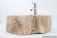 a stone sink with a faucet in the middle