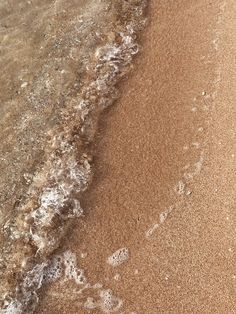 the beach is covered in waves and sand