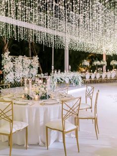 an elegant wedding reception with chandeliers and tables set up for the guests to eat