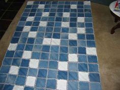 a blue and white rug sitting on top of a floor next to a coffee table