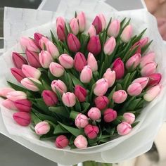 a bouquet of pink tulips on top of a table