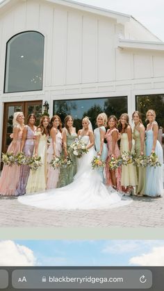 a group of women standing next to each other in front of a white building with windows