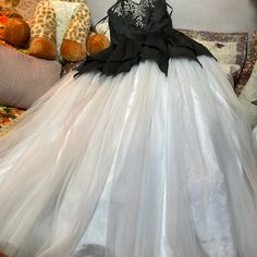 Classic Black And White With Tulle Skirt Attached Underneath Pops Out Like A Cinderella Gown Beautiful Sequins And Just The Right Amount Of Beating At The Top Of The Sweetheart Neckline Elegant Black Ball Gown For Costume Party, White Sleeveless Ball Gown For Prom, Sleeveless White Ball Gown For Prom, Elegant Tulle Evening Dress For Costume Party, White Ball Gown Evening Dress, Black Ruffled Dress For Debutante Ball, White Sleeveless Ball Gown For Evening, White Sleeveless Ruffled Ball Gown, White Tulle Ball Gown Evening Dress