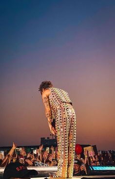 a woman standing on top of a stage in front of a crowd