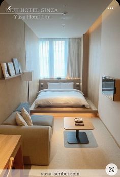 a room with a bed, couch and table in it