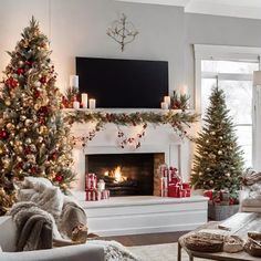 a living room decorated for christmas with presents on the fireplace and trees in front of it