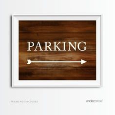 a wooden sign that says parking with an arrow pointing to the right