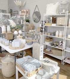 a room filled with lots of white furniture and baskets