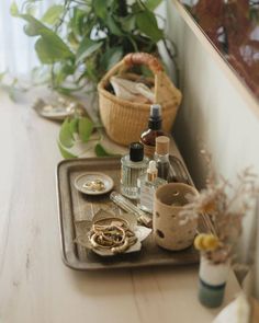 a tray with various items on it next to a potted plant and other things