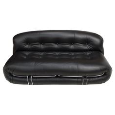 a black leather couch with white piping on the arms and back, sitting against a white background