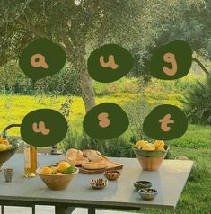 the table is set up outside with fruit and vegetables on it, including lemons