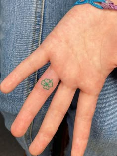 a person's hand with a four leaf clover tattoo on it