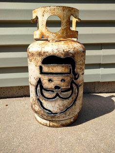 an old gas can with a face drawn on it