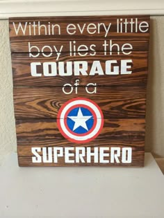 a wooden sign that says, within every little boy lies the courage of a superhero