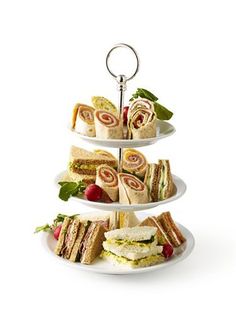 three tiered trays with sandwiches on them