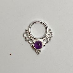 These are soooooo pretty.  Made is 925 sterling silver with tribal details, set with a bright amethyst  stone. The rings are all 1cm (.40") in diameter. The wire is 20 gauge. Stones shine light through them since the back is open. Hard to see this when they are lying flat in the pic. Each piece is made BY HAND One of the images contains numbers to specify which you would like from the drop down menu. Cute Gauges, Cute Septum Rings, Silver Goddess, Septum Piercing Jewelry, Nose Rings Studs, Tooth Gem, Gift Inspo, Septum Jewelry, Septum Piercing