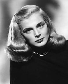 an old black and white photo of a woman with long hair wearing a choker