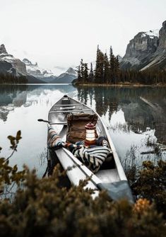 a person is sitting in a canoe on the water