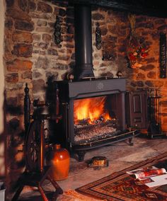 a living room with a fire place and rugs on the floor