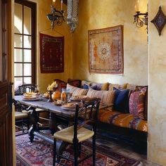 a living room filled with furniture and a rug on top of a wooden dining table