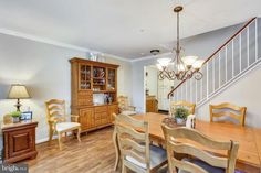 a dining room table with chairs and a chandelier