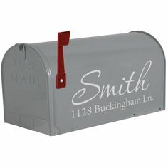 a gray mailbox with the name smith on it's front and red handle