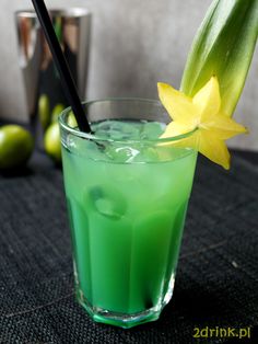 a green drink with a yellow flower in it